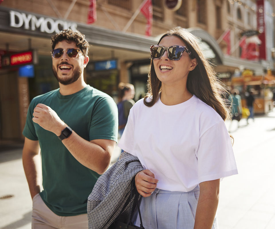 photo of male and female happily shopping