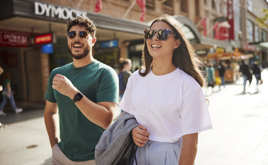 photo of male and female happily shopping