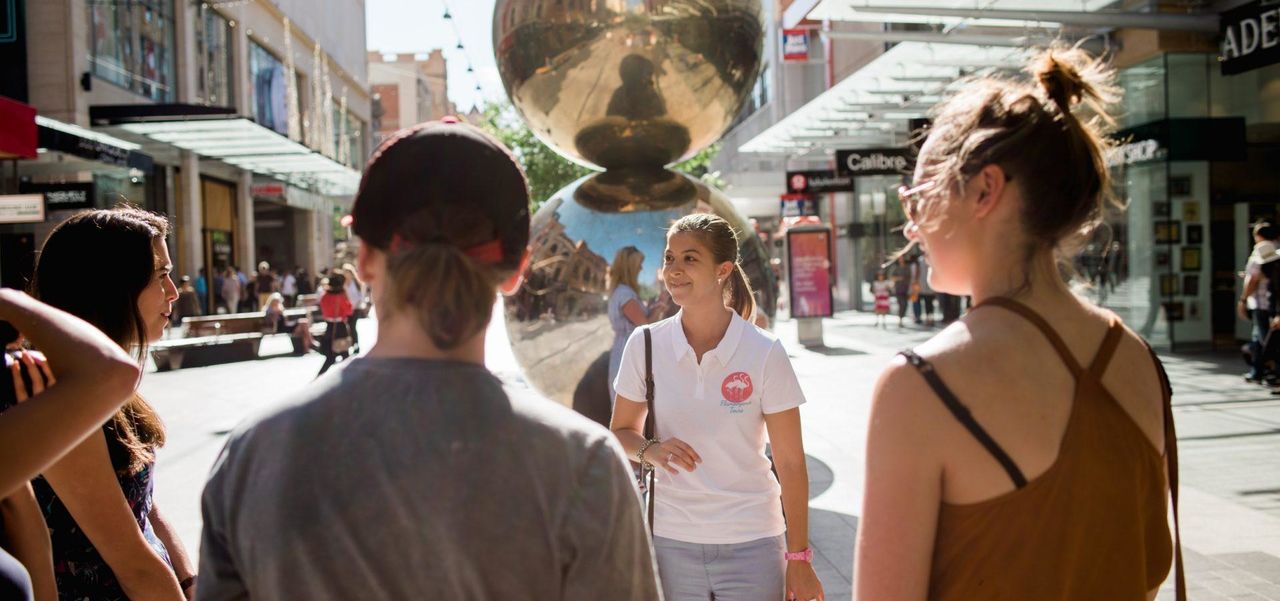 A group of people gathered around the Mall's Balls
