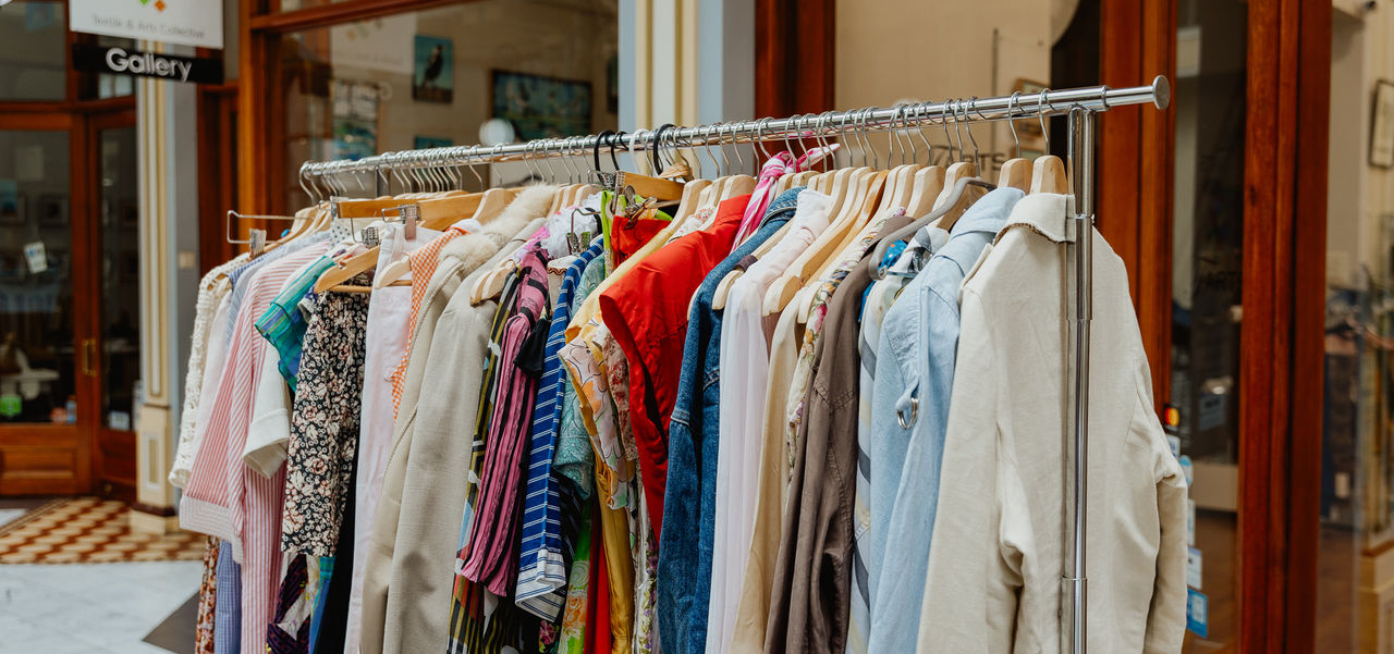 Rack of colourful vintage second hand clothes