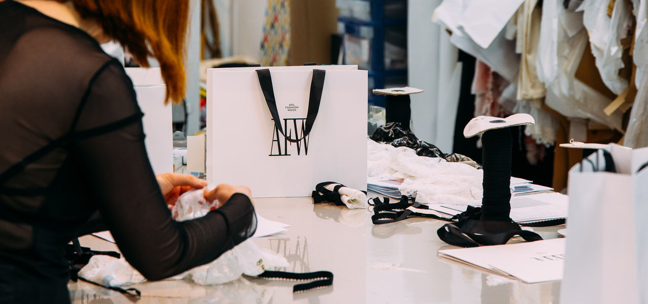 A busy sewing workshop with lots of materials on the table