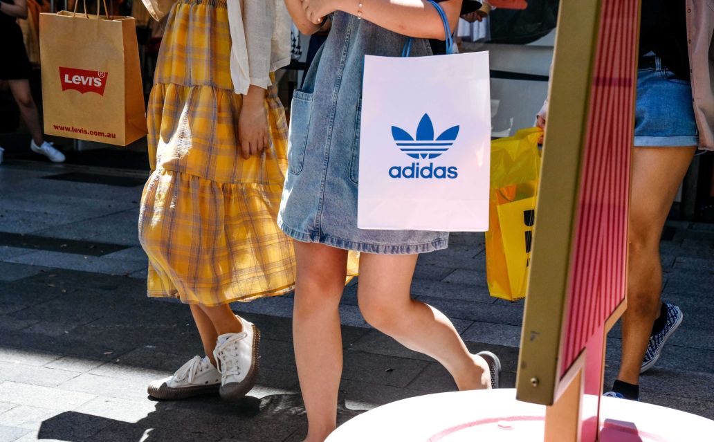 Two women walking in Rundle Mall holding shopping bags