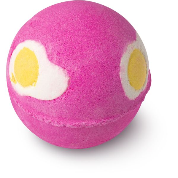 a pink round bath bomb with fried egg pictures