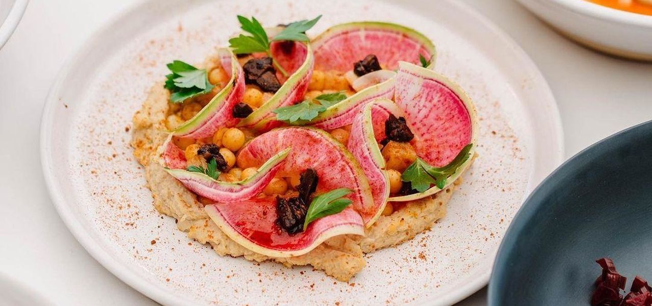 Plates of bright food on a white table at 2KW