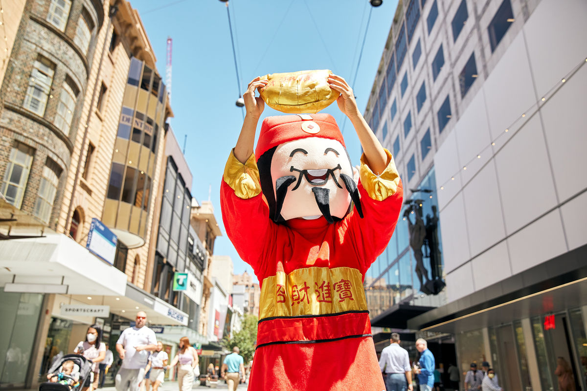 God of Fortune holding up a gold bag