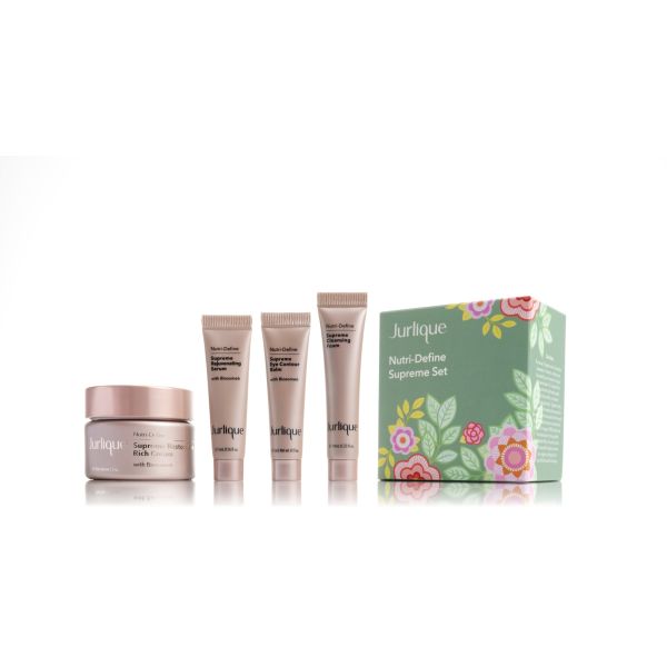 A gift pack line-up of a pearly pink tub of cream, three tubes of cream and a green gift box