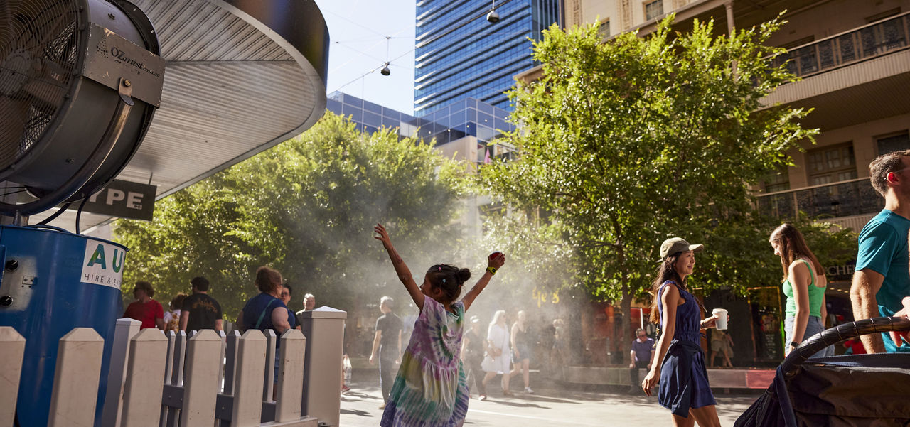 Little girl standing in front of the misting fans in Rundle Mall