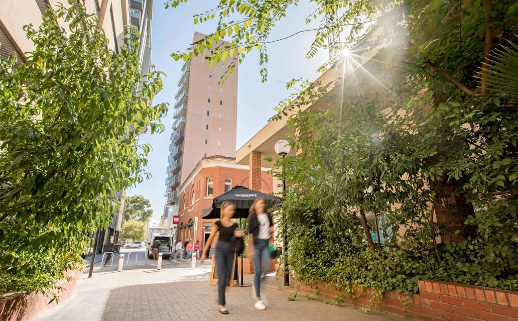 Two people walking through the city