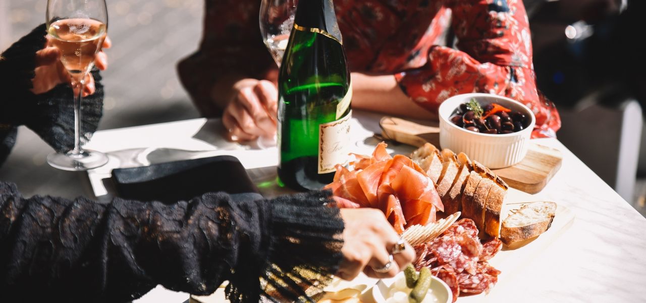 A plate of food in front of two diners