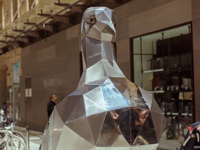A close up of a large metal pigeon sculpture