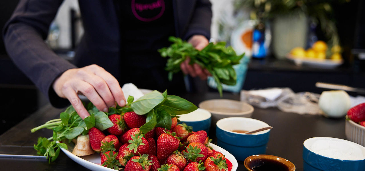 Plate of strawberries with a bunch of basil