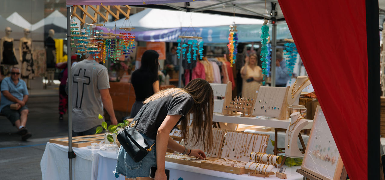 A shopper looking at jewellery at a stall at the Market in the Mall
