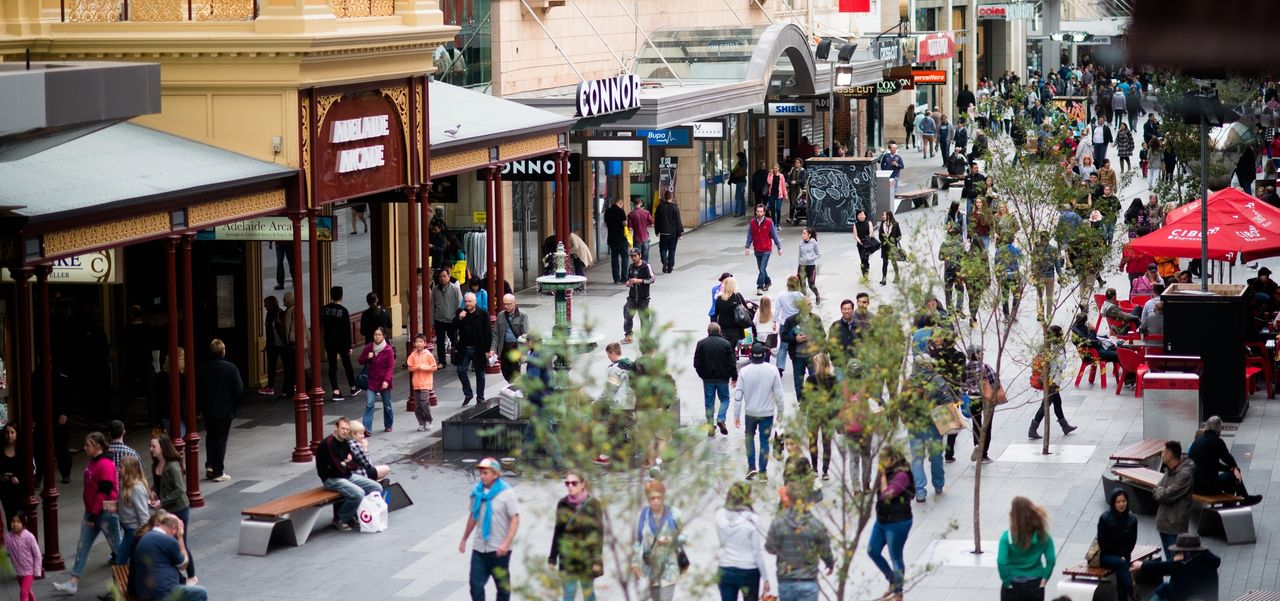 A crowd of people walking through Rundle Mall