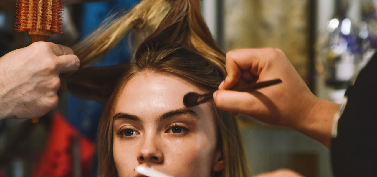 A model having her hair and make up done