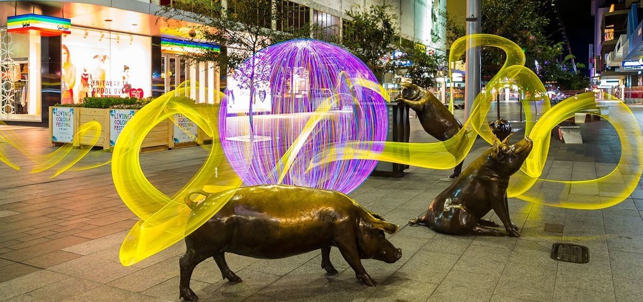 Lights swirling around the Rundle Mall pig statues