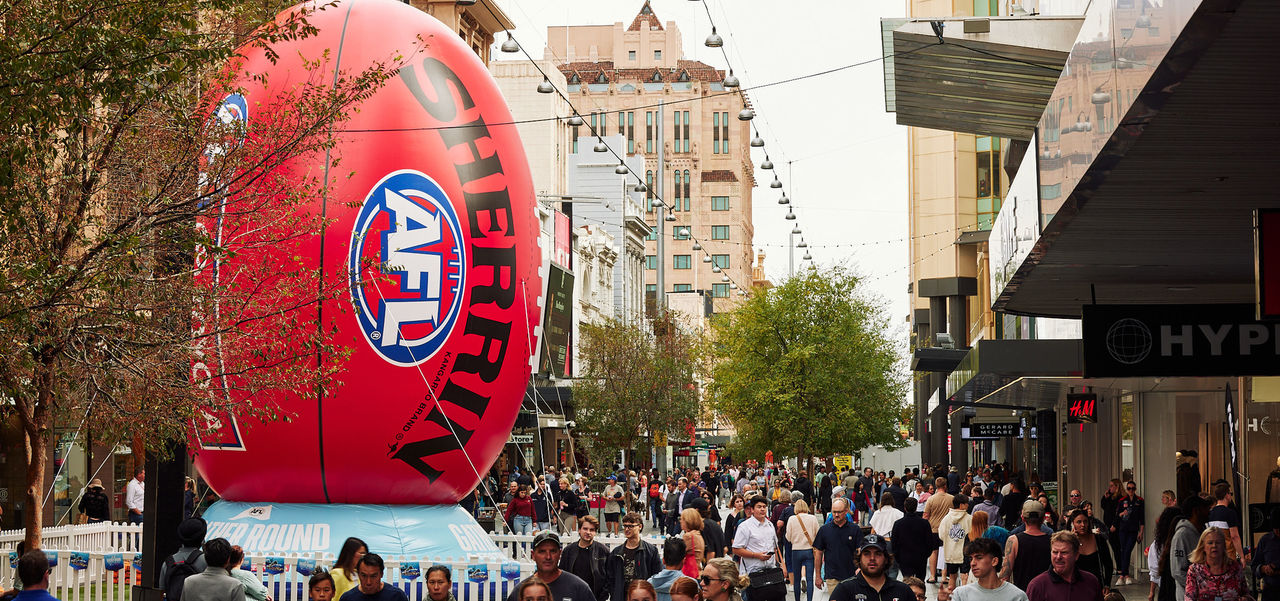 Giant footy and lots of shoppers in the busy Mall