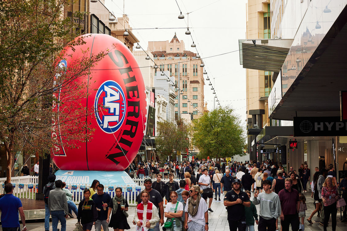 Giant footy and lots of shoppers in the busy Mall