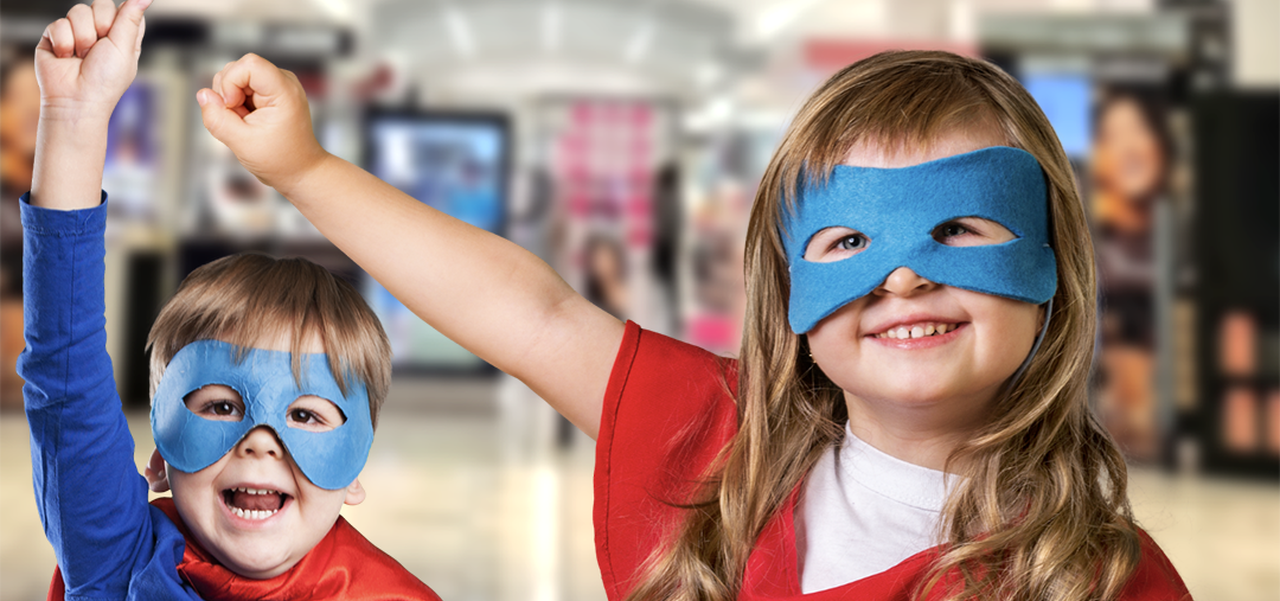 Kids in superhero costumes in front of the Myer Cetnre