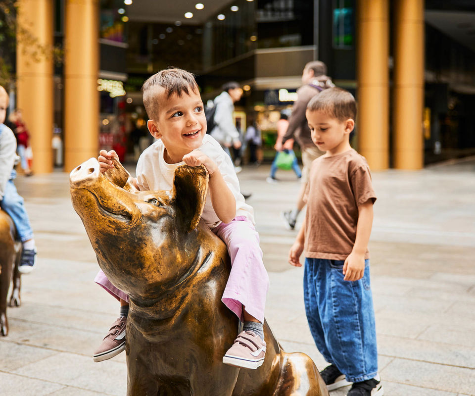 Kids playing on the Rundle Mall pigs