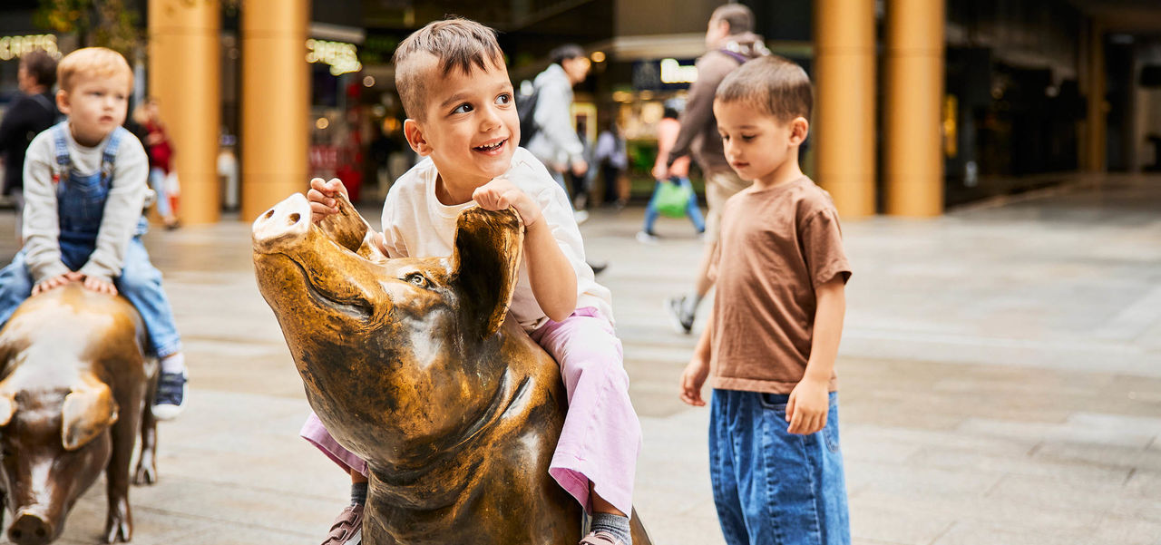 Kids playing on the Rundle Mall pigs